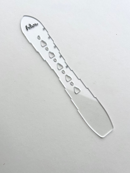 Leather belt hole template on a grey background