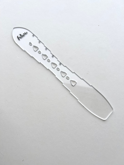 Leather belt hole template on a grey background