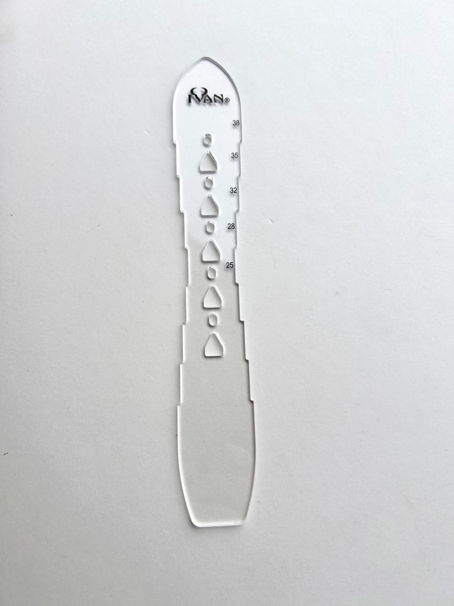 Leather belt hole template on a grey background