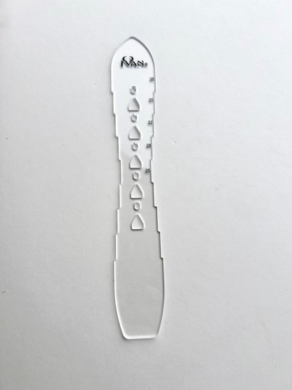 Leather belt hole template on a grey background