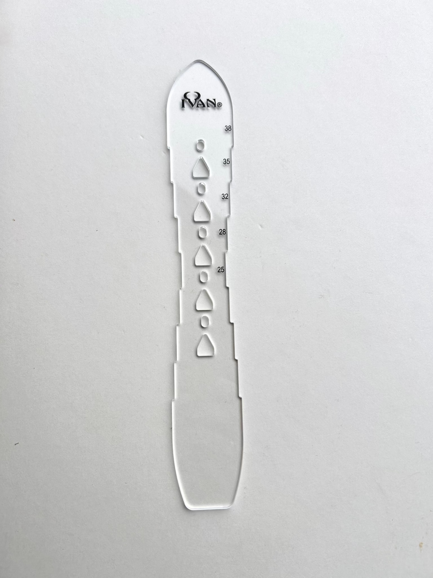 Leather belt hole template on a grey background