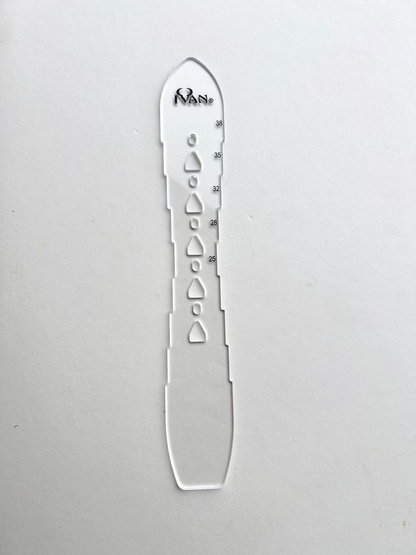 Leather belt hole template on a grey background