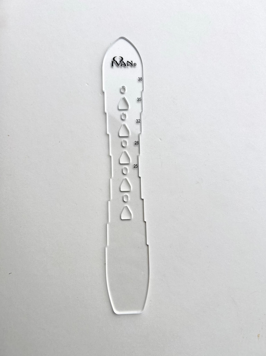 Leather belt hole template on a grey background