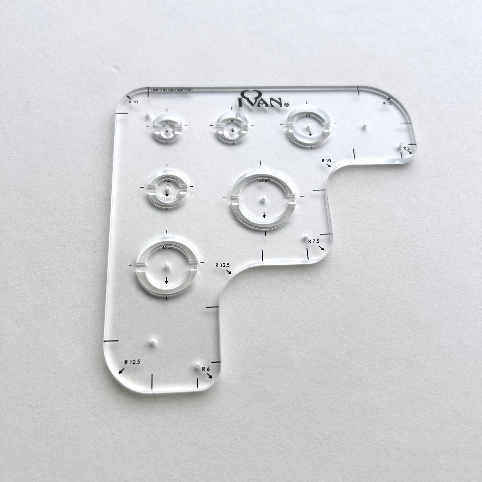 Leather wallet corner radius template on a grey background