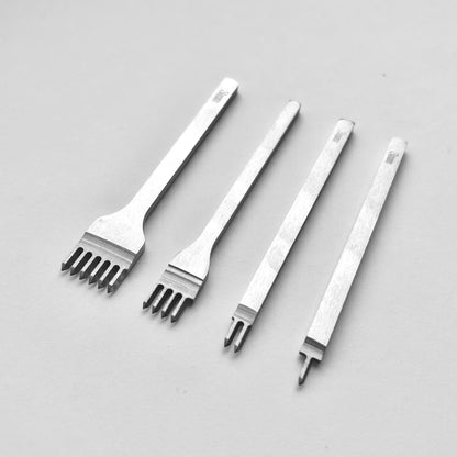 Set of four metal leather stitching punches on a light grey background