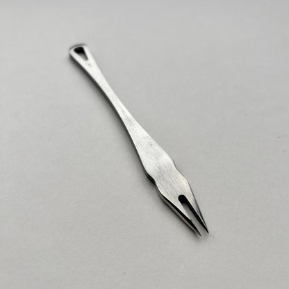 Metal distance gauge tool on a piece of leather