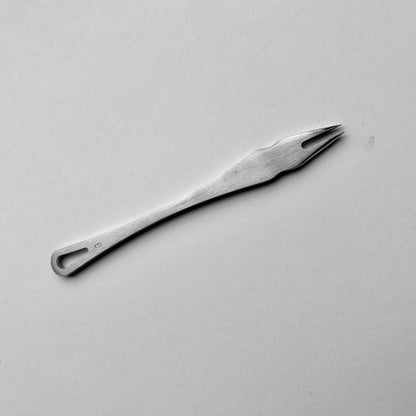 Metal distance gauge tool on a piece of leather
