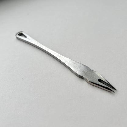 Metal distance gauge tool on a piece of leather