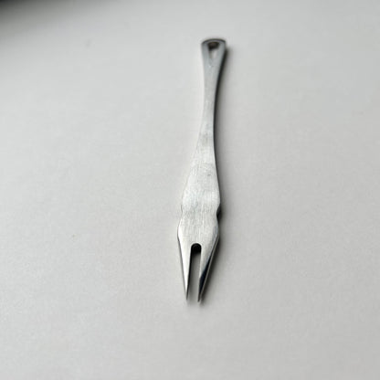 Metal distance gauge tool on a piece of leather