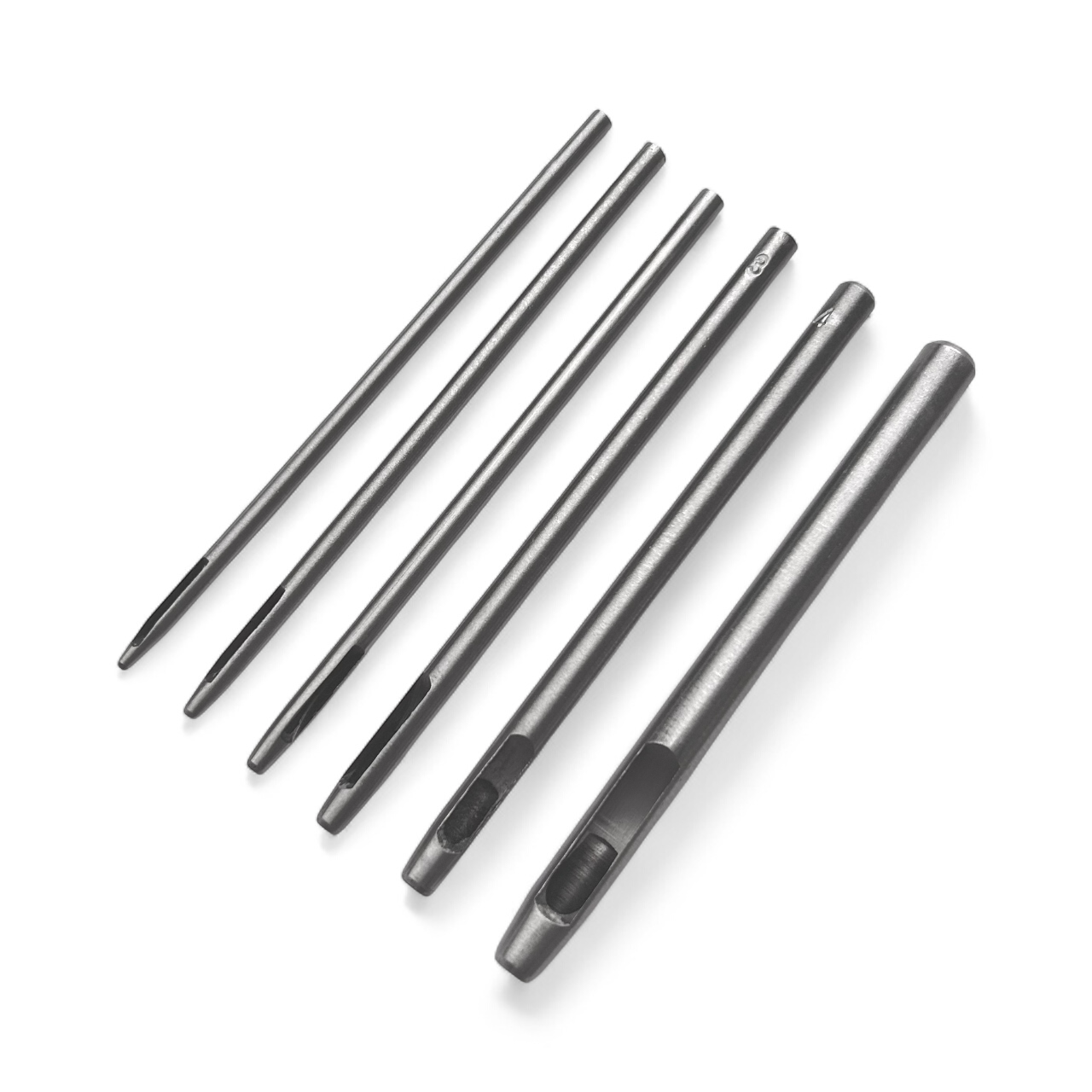 Set of six silver leather drive punches on a white background