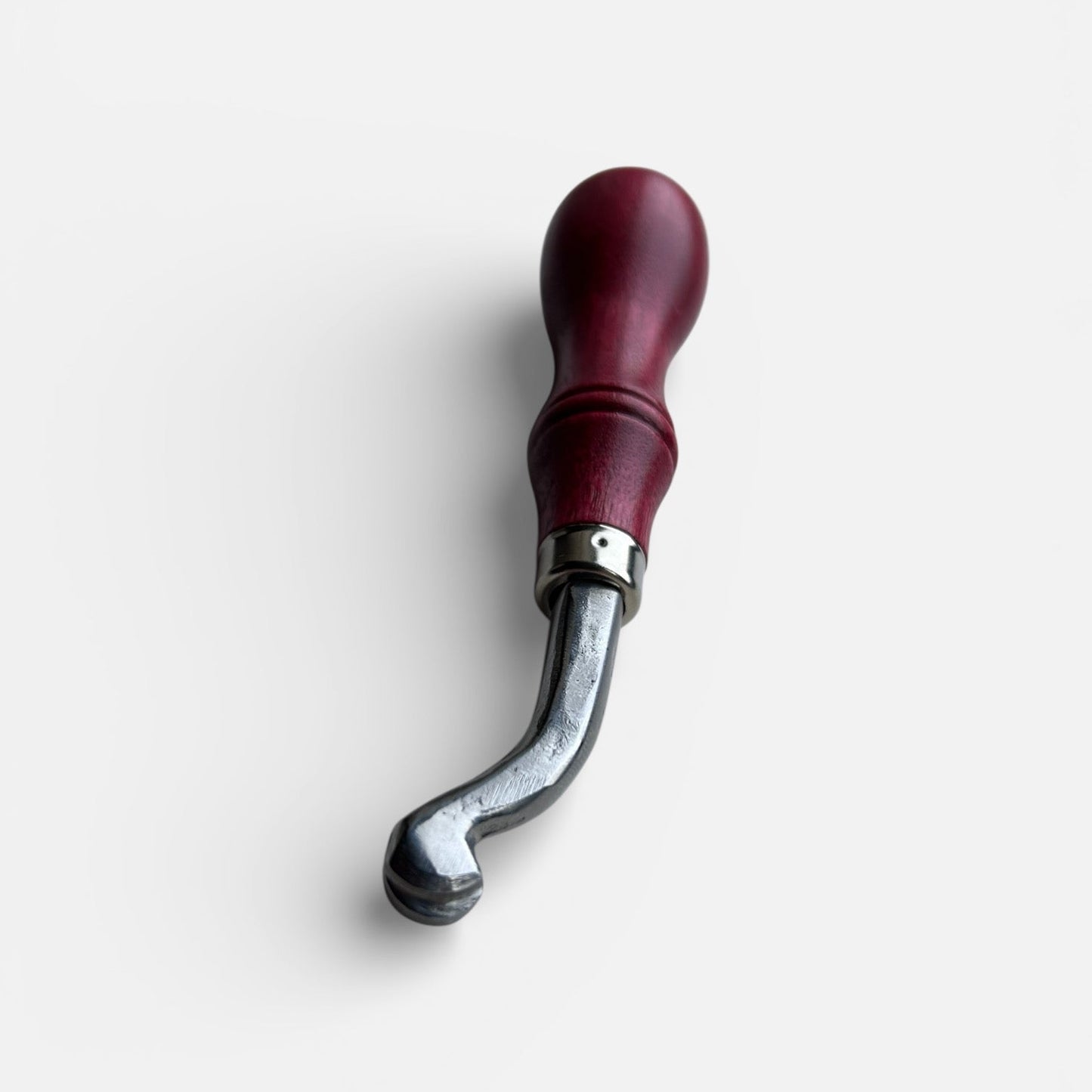 Metal tool with red handle on a white background