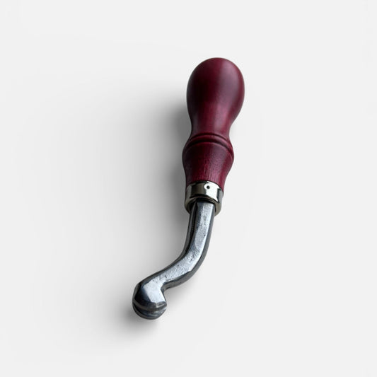 Metal tool with red handle on a white background