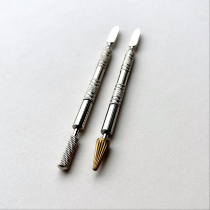Two metallic leather edge dye pen tools with decorative patterns on a white background
