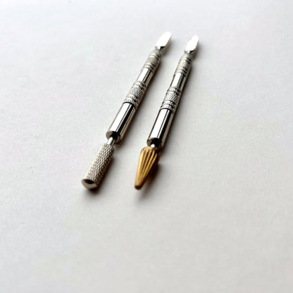 Two metallic leather edge dye pen tools with decorative patterns on a white background