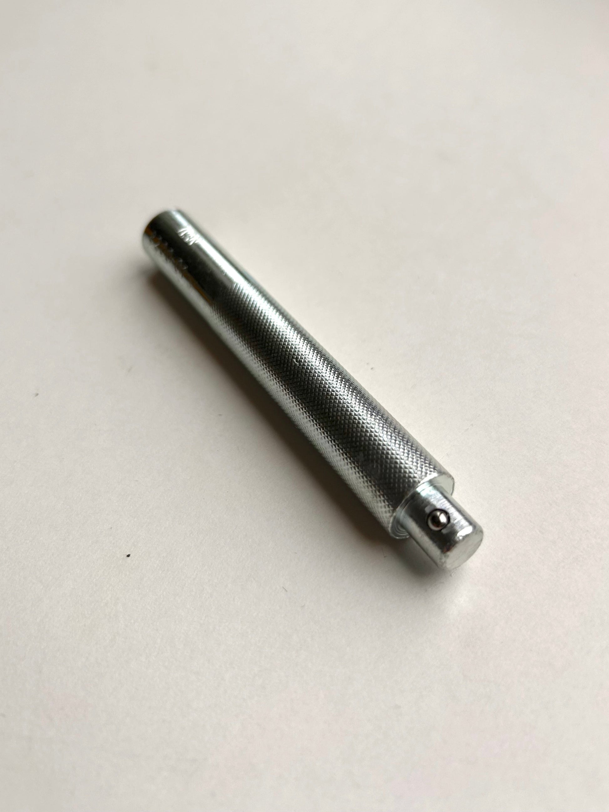 Metal leather embossing tool on a white background