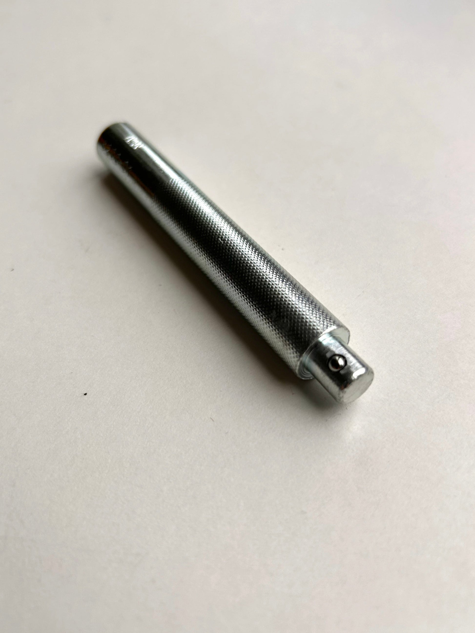 Metal leather embossing tool on a white background