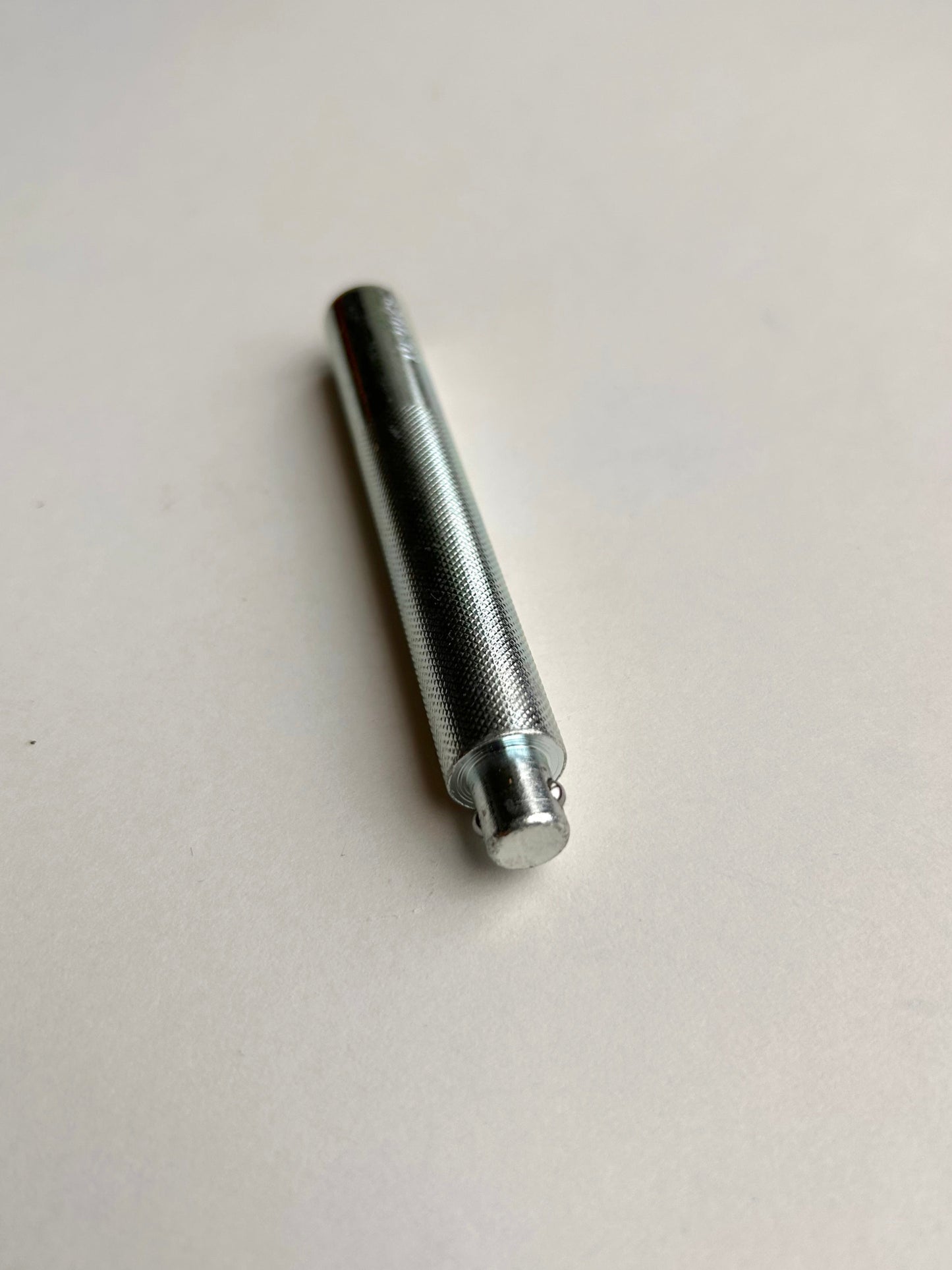 Metal leather embossing tool on a white background