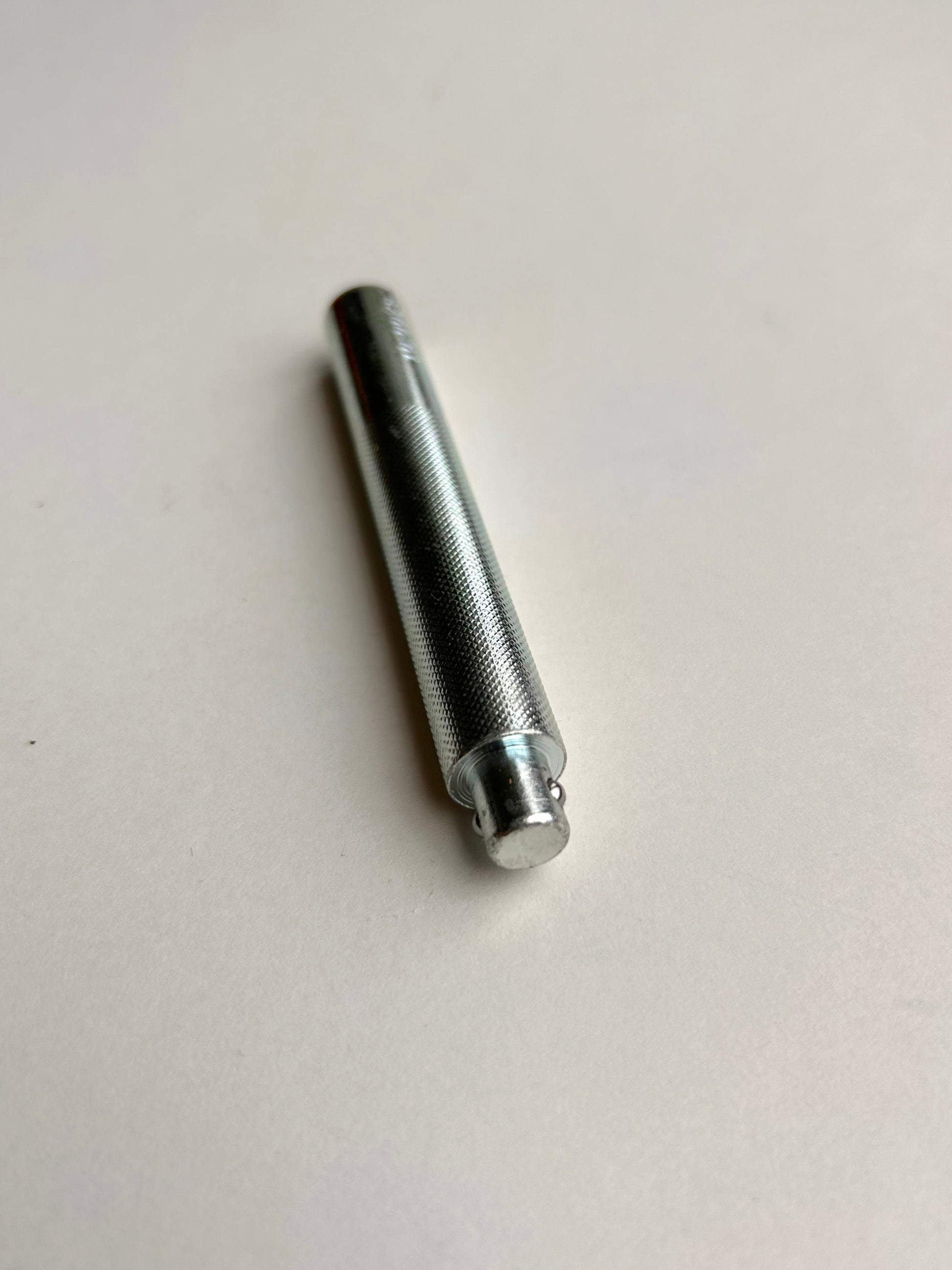 Metal leather embossing tool on a white background