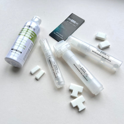Set of adhesive products and small white blocks on a light gray background