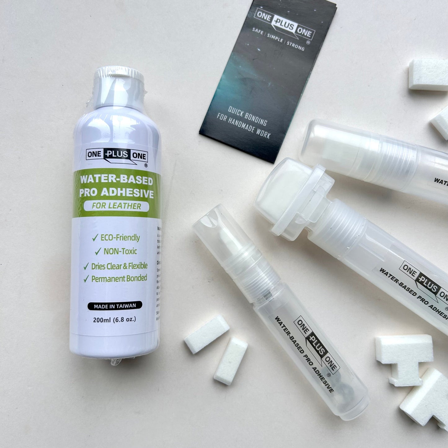 Water-based pro adhesive for leather with packaging on a light gray background