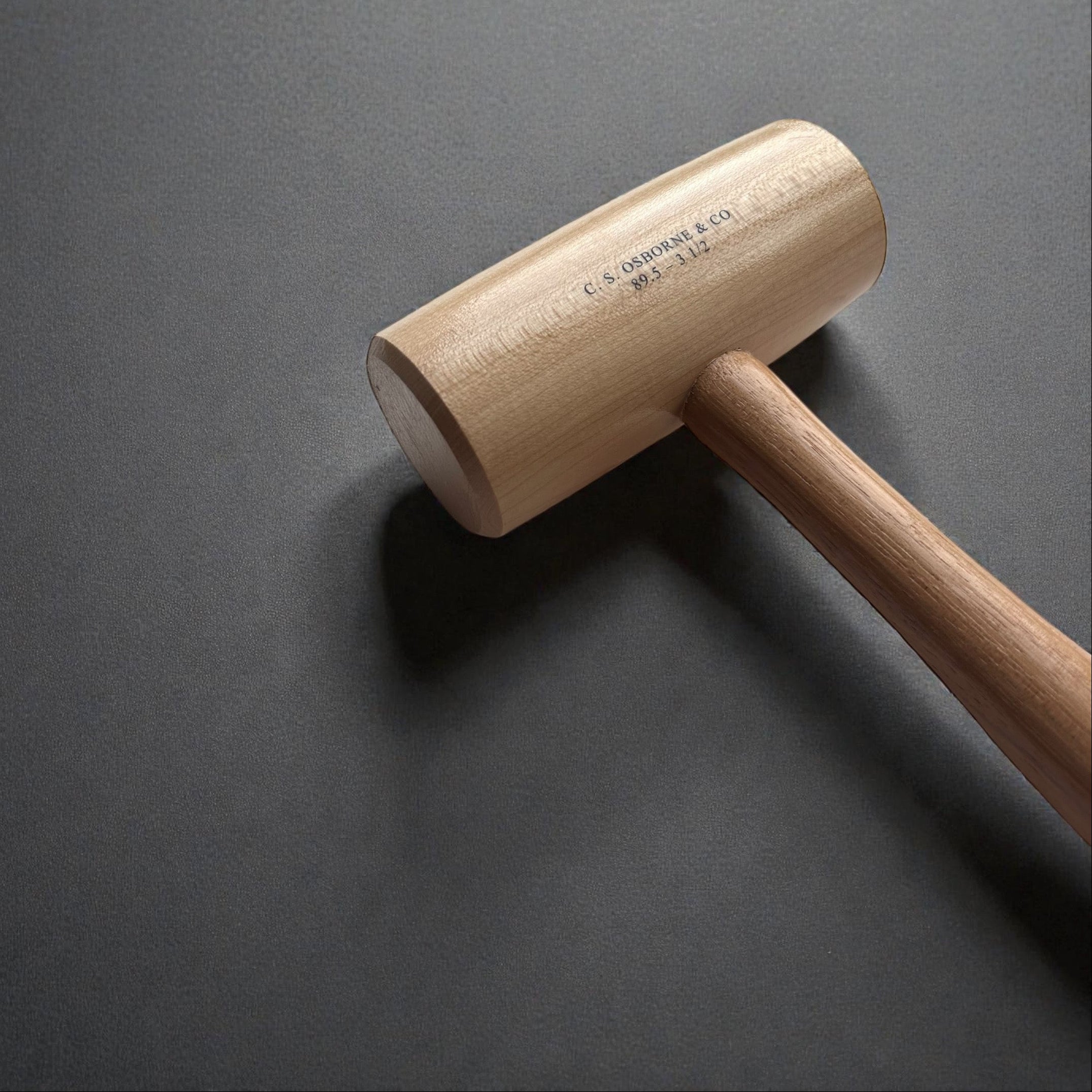 Wooden mallet on a dark gray background