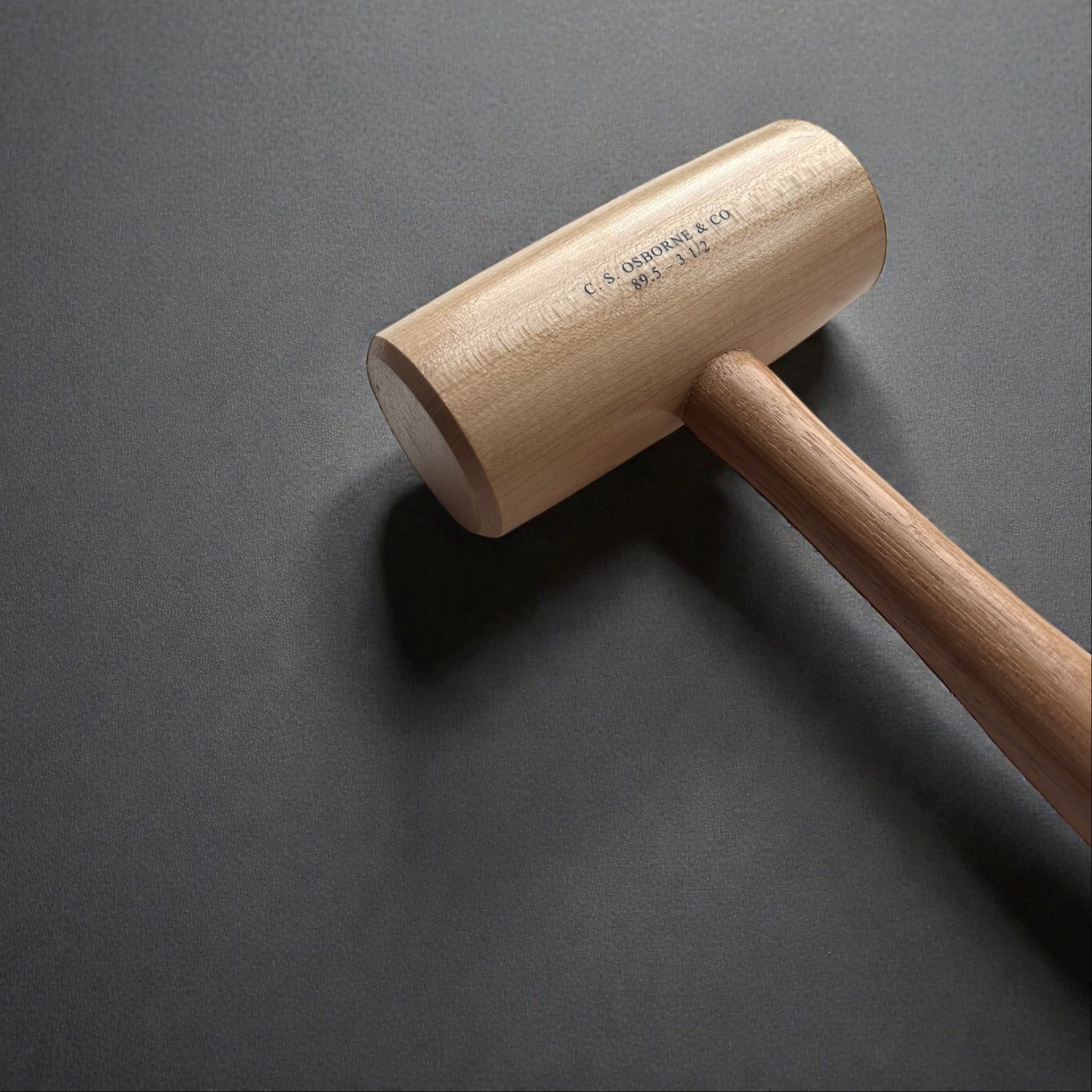 Wooden mallet on a dark gray background