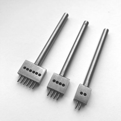 Three metal leather stitching punches with  on a white background