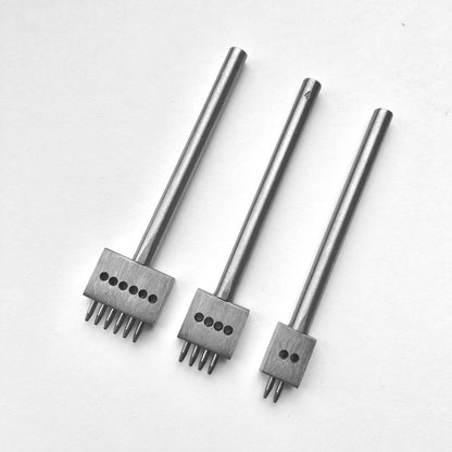 Three metal leather stitching punches with  on a white background