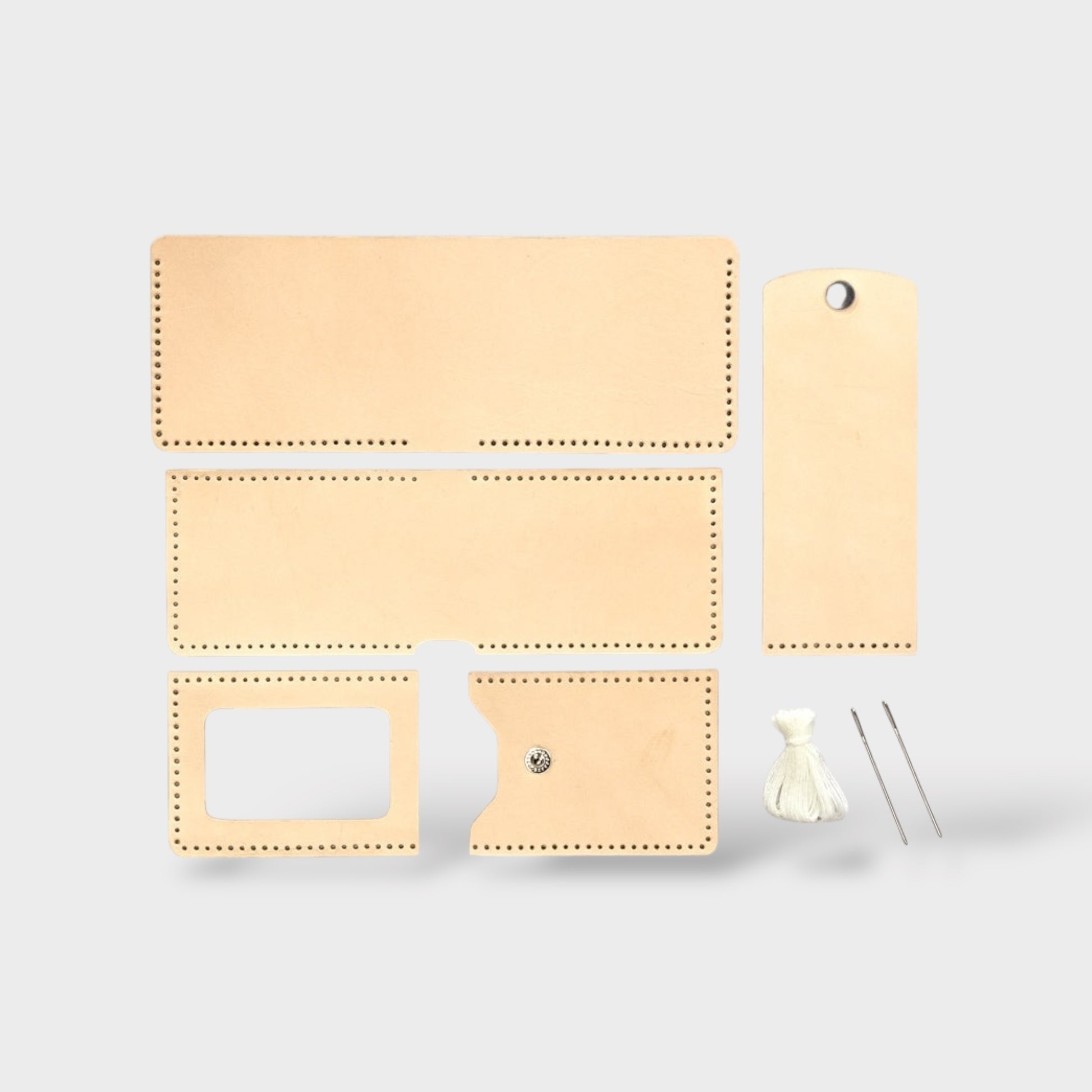 Set of beige leather wallet pieces with various compartments on a light gray background