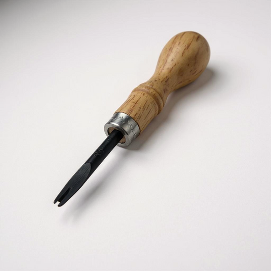 Wooden-handled leather edge beveller tool on a white background