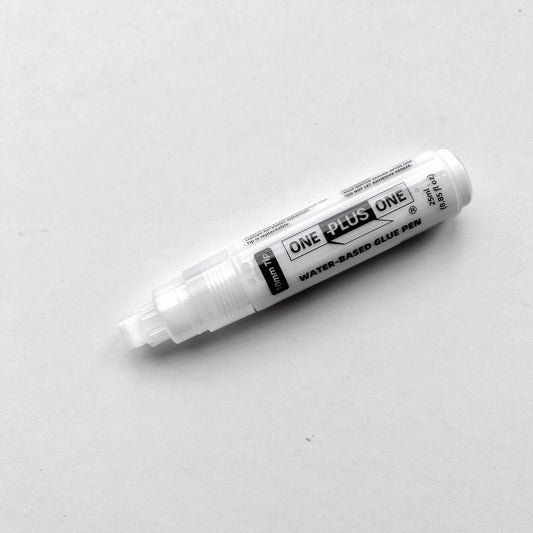 White glue pen labeled 'One Plus One' on a light gray background