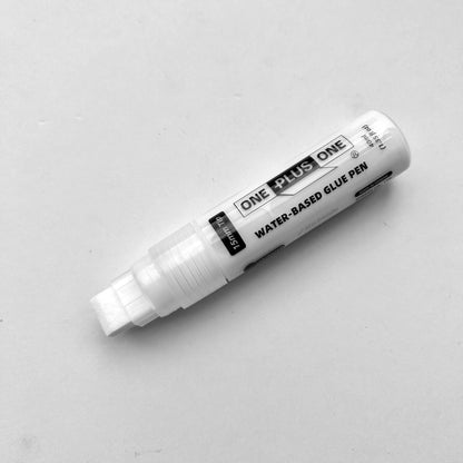 White water-based glue pen with 'One Plus One' branding on a light gray background