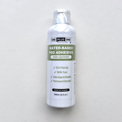 Bottle of water-based pro adhesive for leather on a white background