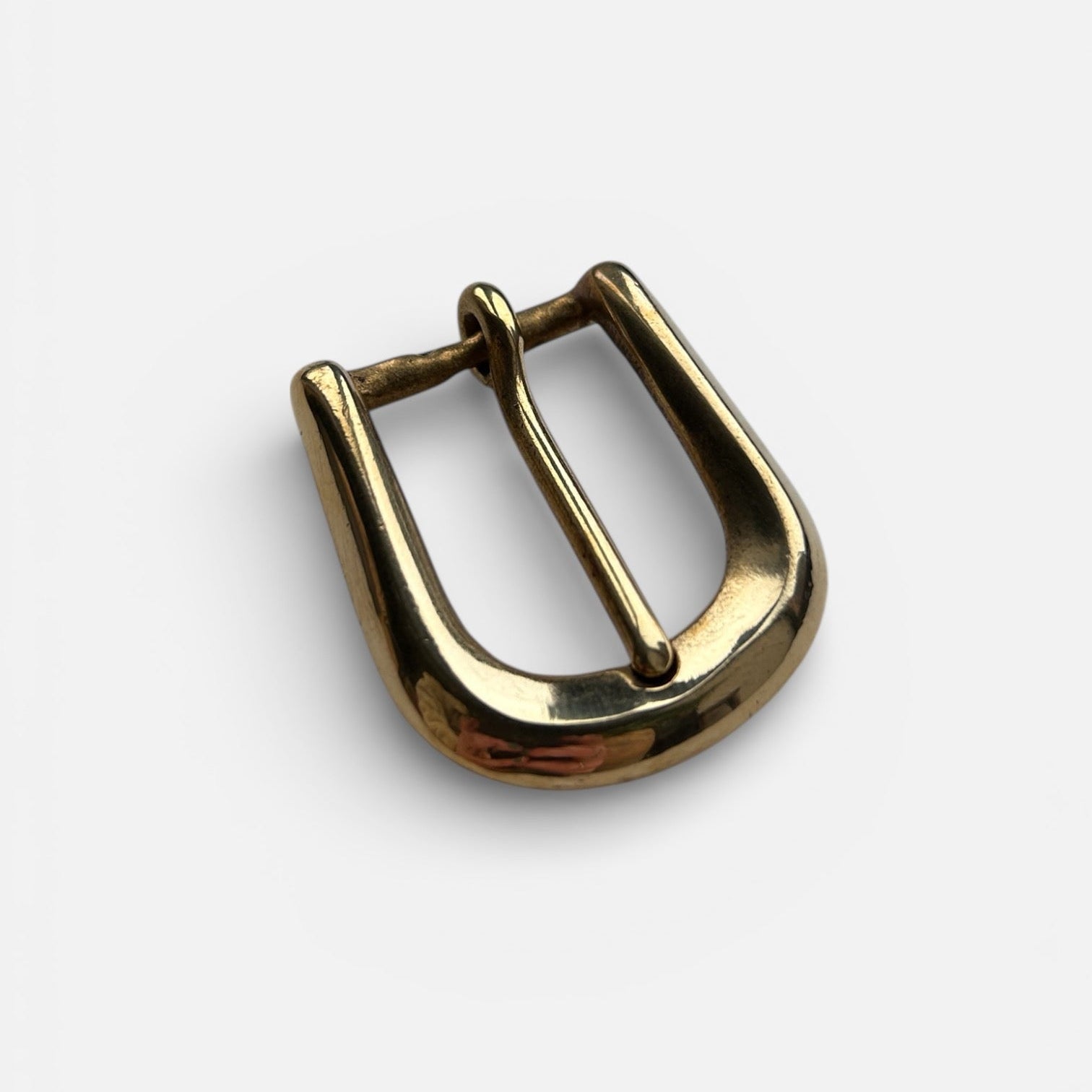 Gold metal buckle on a white background
