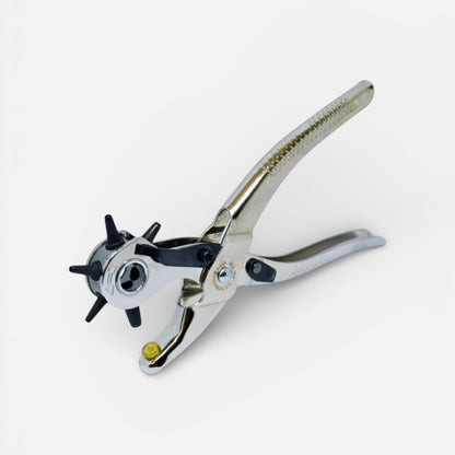 Metal hole punch on a white background