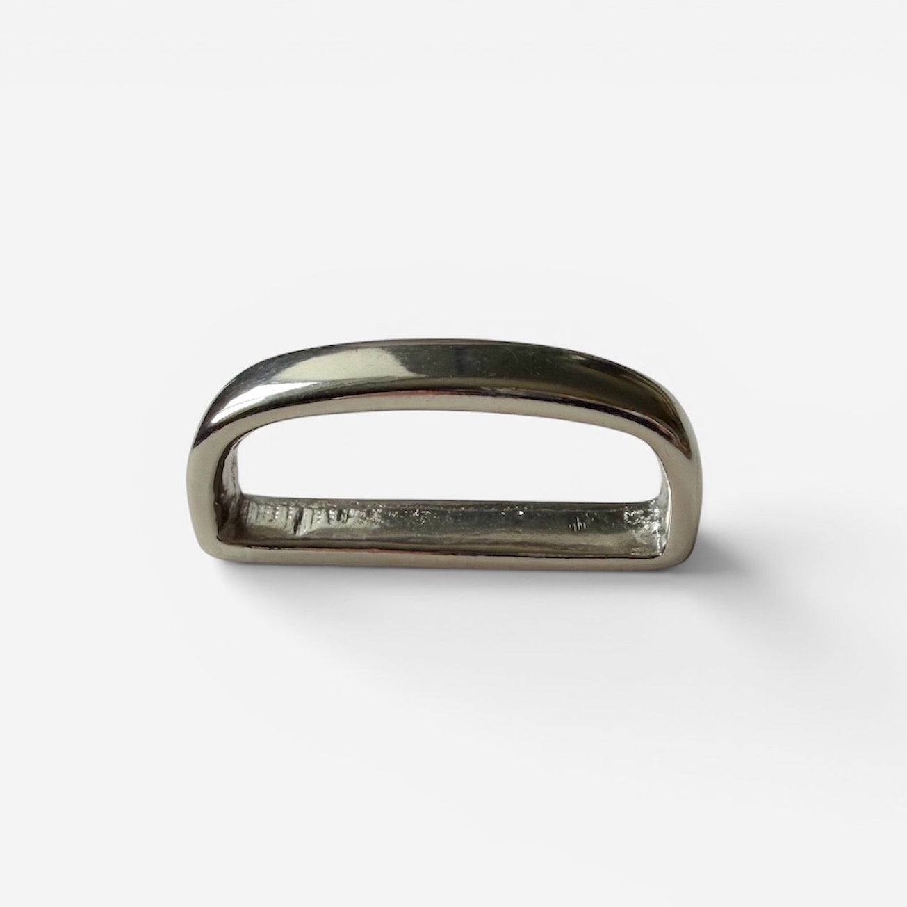 Silver belt loop keeper on a white backround
