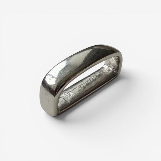 Silver belt loop keeper on a white backround