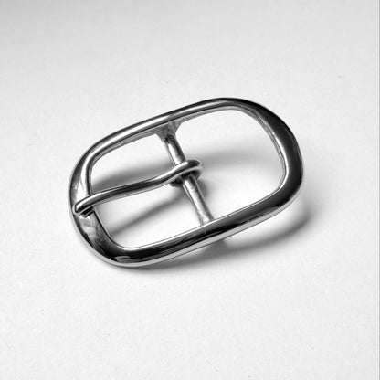 A polished silver metal belt buckle with a rounded rectangular shape and a single prong, photographed on a clean white background.