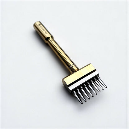 Gold-colored Sinabroks leather pricking iron tool on a light gray background