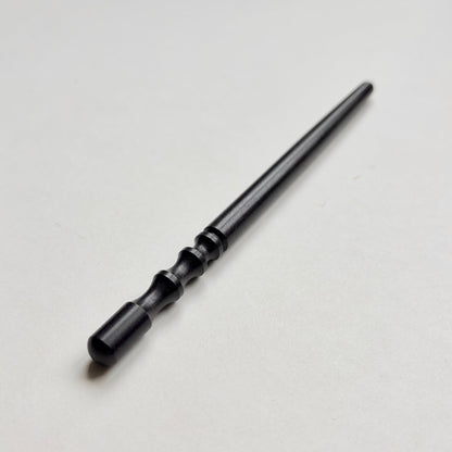 Narrow black wooden leather edge burnisher tool on a grey background