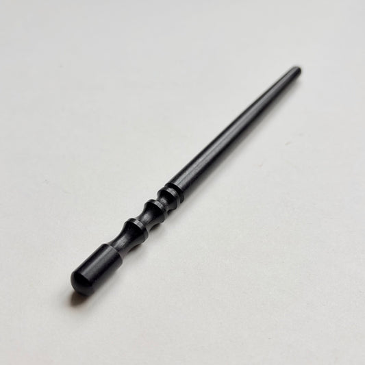 Narrow black wooden leather edge burnisher tool on a grey background
