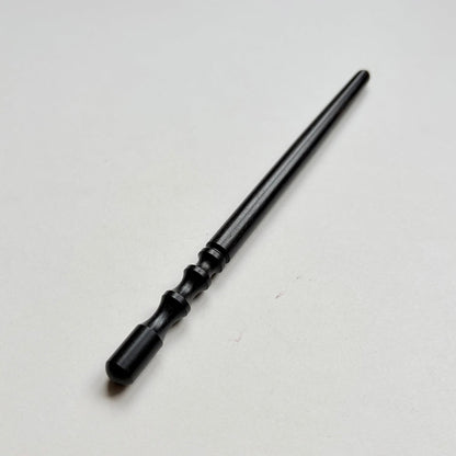 Narrow black wooden leather edge burnisher tool on a grey background