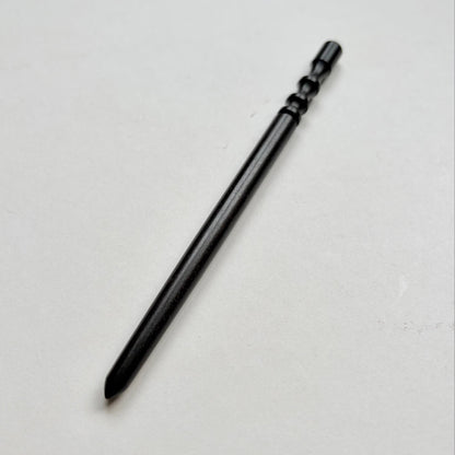 Narrow black wooden leather edge burnisher tool on a grey background
