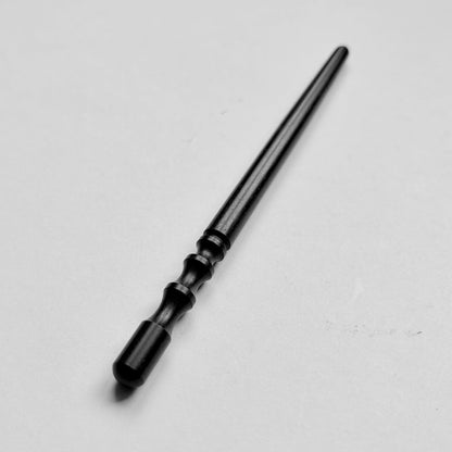 Narrow black wooden leather edge burnisher tool on a grey background