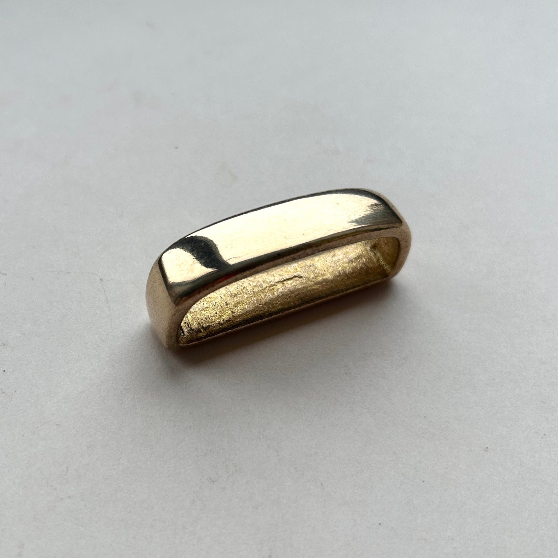 Solid brass belt loop keeper  on a white background