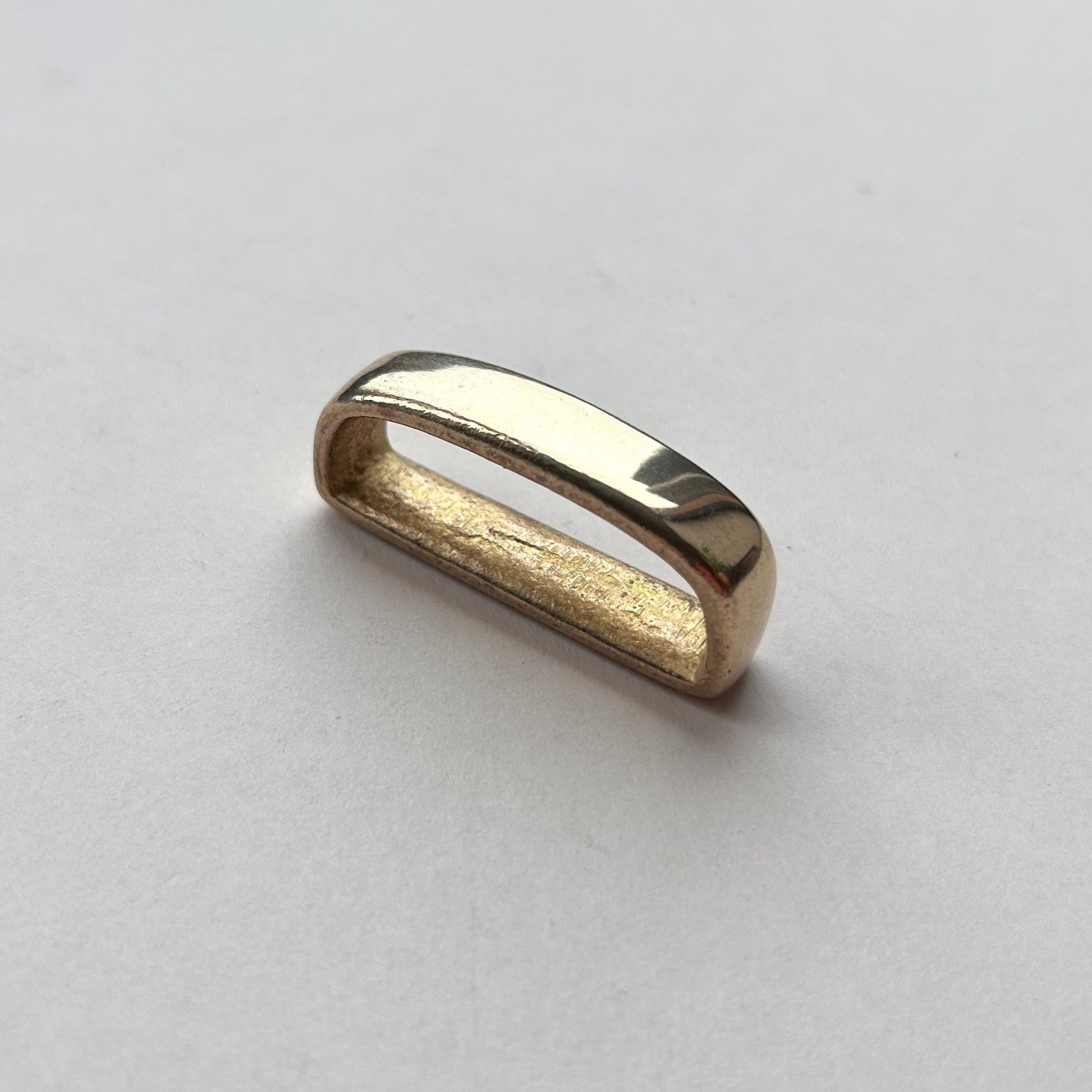 Solid brass belt loop keeper  on a white background