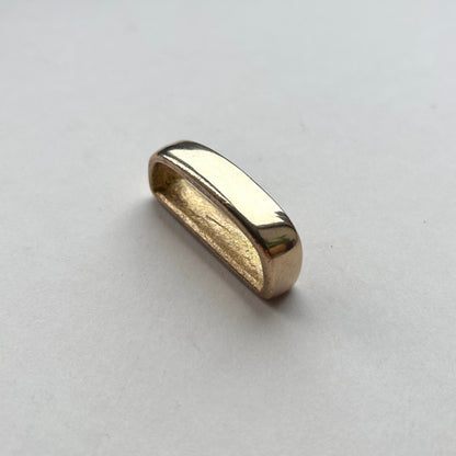 Solid brass belt loop keeper  on a white background