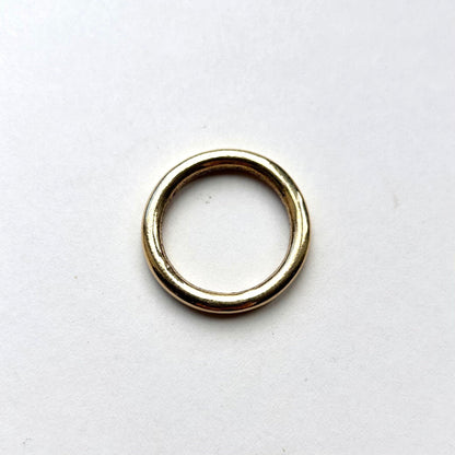 Gold solid brass o ring on a white background