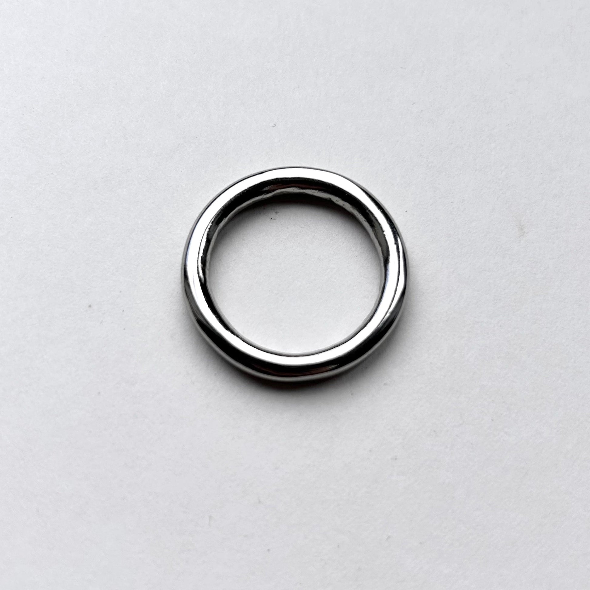 Silver o ring for leathercraft on a light gray background