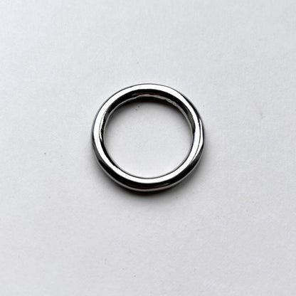 Silver o ring for leathercraft on a light gray background
